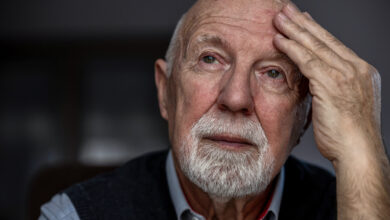 Portrait of a senior man suffering from a headache