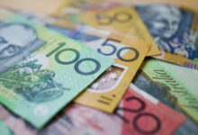 Australian money background showing $100, $50 and $20 notes with a shallow depth of field.