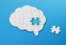 Brain shaped white jigsaw puzzle on blue background, a missing piece of the brain puzzle, mental health and problems with memory