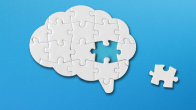 Brain shaped white jigsaw puzzle on blue background, a missing piece of the brain puzzle, mental health and problems with memory