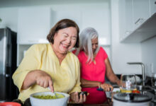 Mature women preparing guacamole at a domestic kitchen