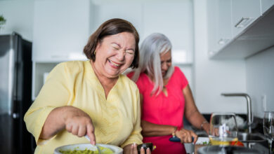 Mature women preparing guacamole at a domestic kitchen