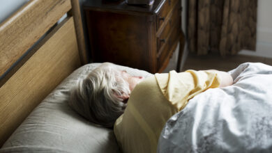 Elderly caucasian woman sleeping on the bed