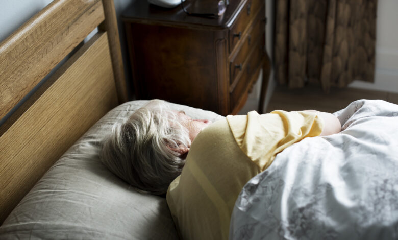 Elderly caucasian woman sleeping on the bed