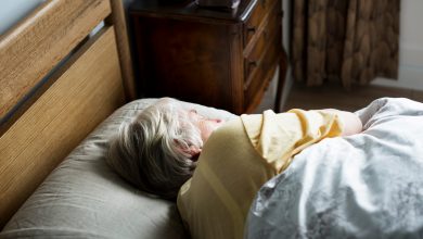 Elderly caucasian woman sleeping on the bed