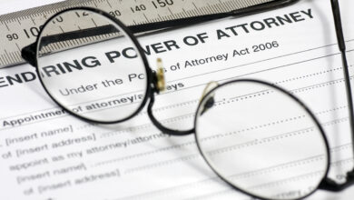 Close up of Power of Attorney contract with reading glasses