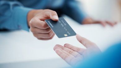 Corporate hands exchange credit card to accountant for payment for company tax bills, money loan and accounting fees. Businessman with banking card to invest in financial savings budget investment