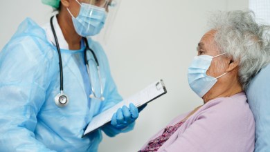 Doctor check Asian elder senior woman patient wearing a mask for protect covid coronavirus.