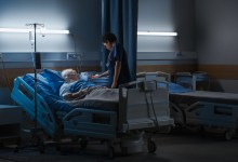 Hospital Ward: Portrait of Elderly Man Wearing Oxygen Mask Resting in Bed, Struggling to Recover after Covid-19, Sickness, Disease, Surgery. Old Man Fighting for His Life. Dark Blue Sad Shot