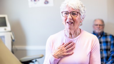 Senior consulting with doctor in exam room