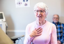 Senior consulting with doctor in exam room