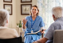 Nurse explaining and interacting with seniors at nursing home. Group of old men and women listening to young nurse on the change of therapy. Psychological support with counselor therapist for a group of elderly people during therapy counseling session.