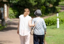 A park with good atmosphere with canal in Toyama Prefecture. Old woman in her 90s and Japanese woman in her thirties are walking around the park.