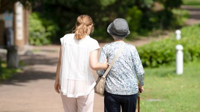 A park with good atmosphere with canal in Toyama Prefecture. Old woman in her 90s and Japanese woman in her thirties are walking around the park.