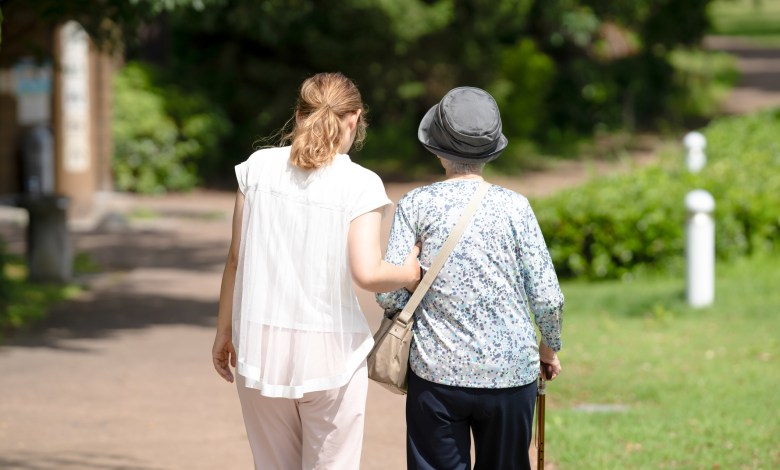 A park with good atmosphere with canal in Toyama Prefecture. Old woman in her 90s and Japanese woman in her thirties are walking around the park.