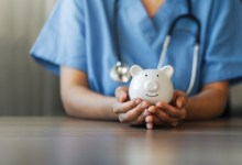 Nurse or doctor with stethoscope holding piggy bank in hand. Concept of medical expenses, finance, saving money, health insurance, medicine, donation and pension. Healthcare service cost.