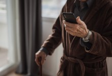 Senior man text messaging via smart phone
