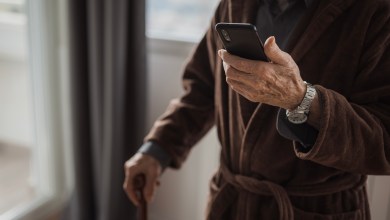 Senior man text messaging via smart phone