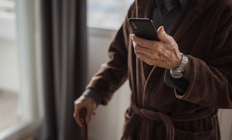 Senior man text messaging via smart phone