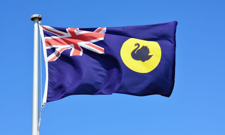Close-up of Western Australia flag in blue sky background.