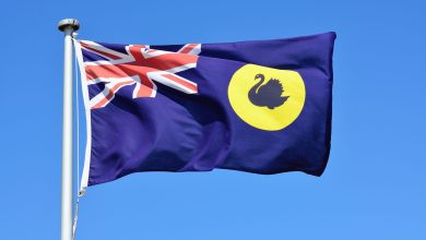 Close-up of Western Australia flag in blue sky background.