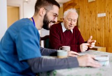 Home caretaker – man helping senior man