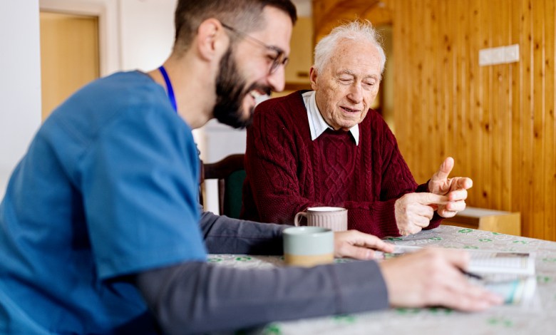 Home caretaker – man helping senior man
