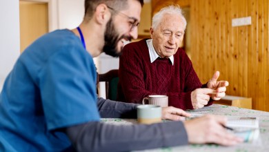 Home caretaker – man helping senior man