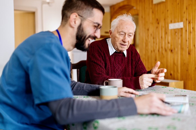 Home caretaker – man helping senior man