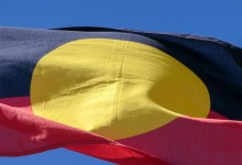 The Australian Aboriginal flag flies on one of the flagpoles outside Parliament House, Canberra. This image was taken on a sunny afternoon on 8 October 2023.