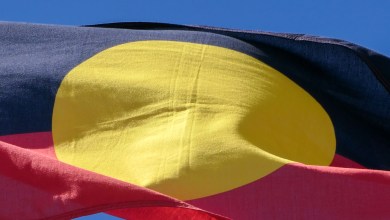 The Australian Aboriginal flag flies on one of the flagpoles outside Parliament House, Canberra. This image was taken on a sunny afternoon on 8 October 2023.