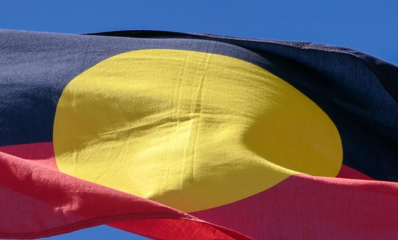 The Australian Aboriginal flag flies on one of the flagpoles outside Parliament House, Canberra. This image was taken on a sunny afternoon on 8 October 2023.
