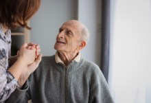 Elderly man looking at his daughter with love