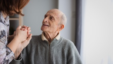 Elderly man looking at his daughter with love